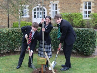 Pupils tree planting working in partnership