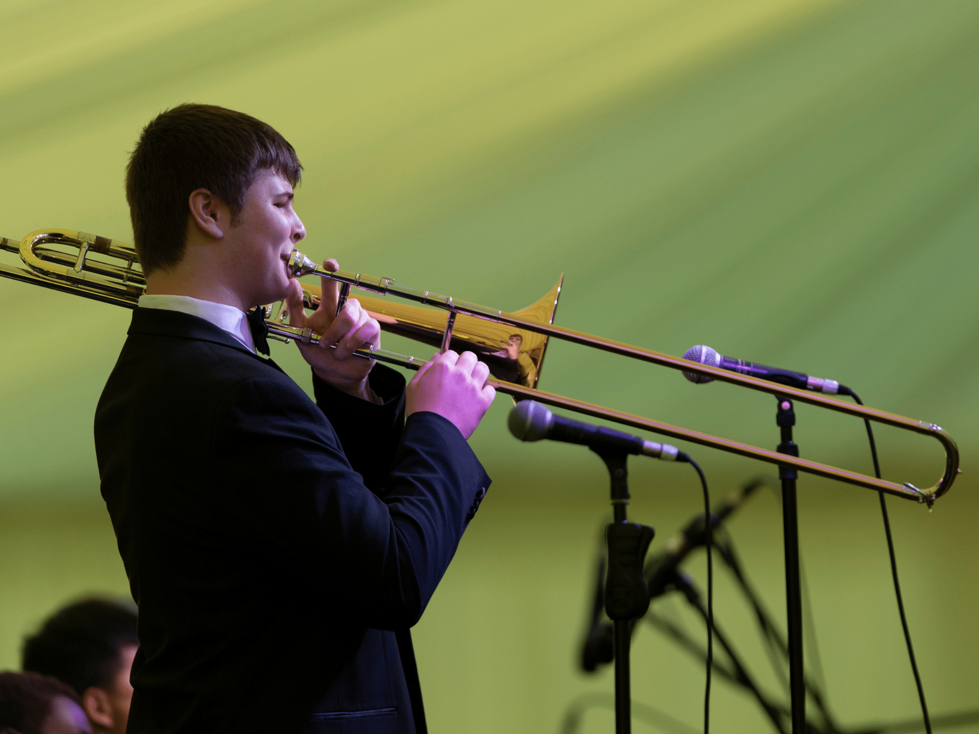 Student plays trombone in marquee concert