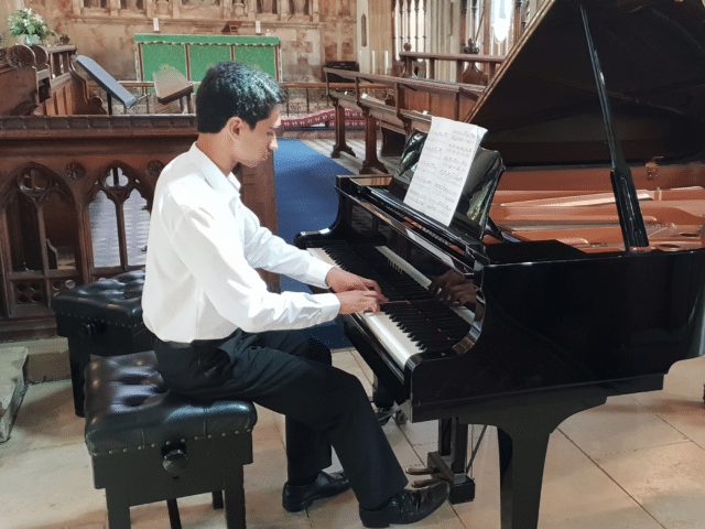 Student plays piano in concert