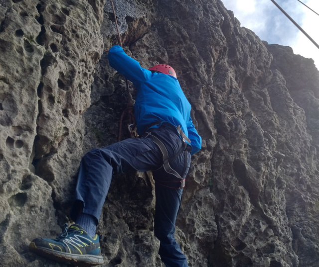 A pupil rock climbing